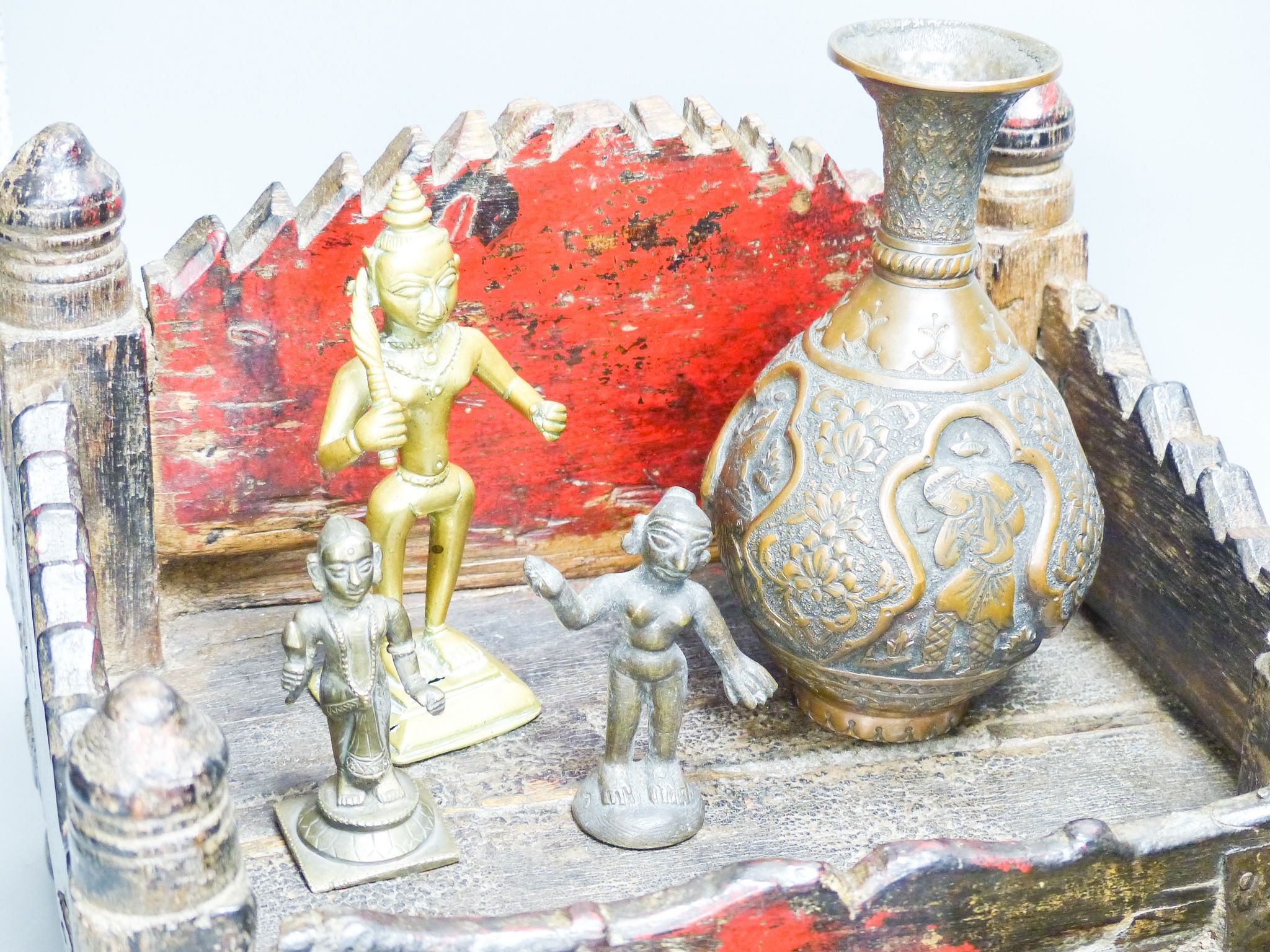 An Indian shrine stand, metalware figures and vessels (9), stand 29.5 cm wide